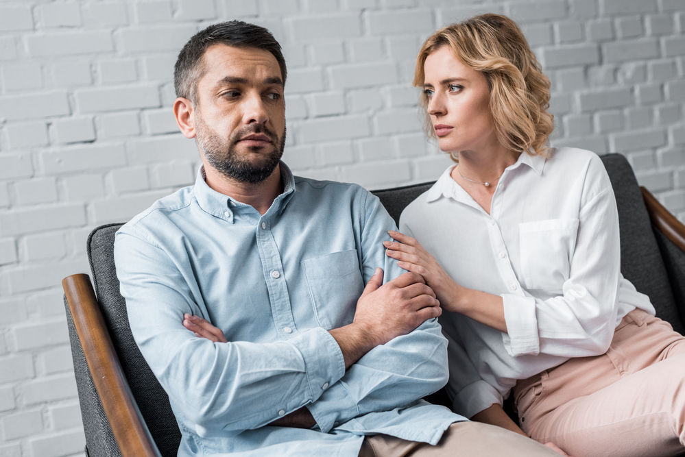 A man with his wife who is trying to help her husband seek out inpatient treatment at Olympus Recovery, a leading Zelis rehab, for his drug addiction