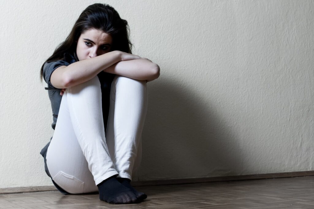 women on floor wondering about bipolar suicide rates