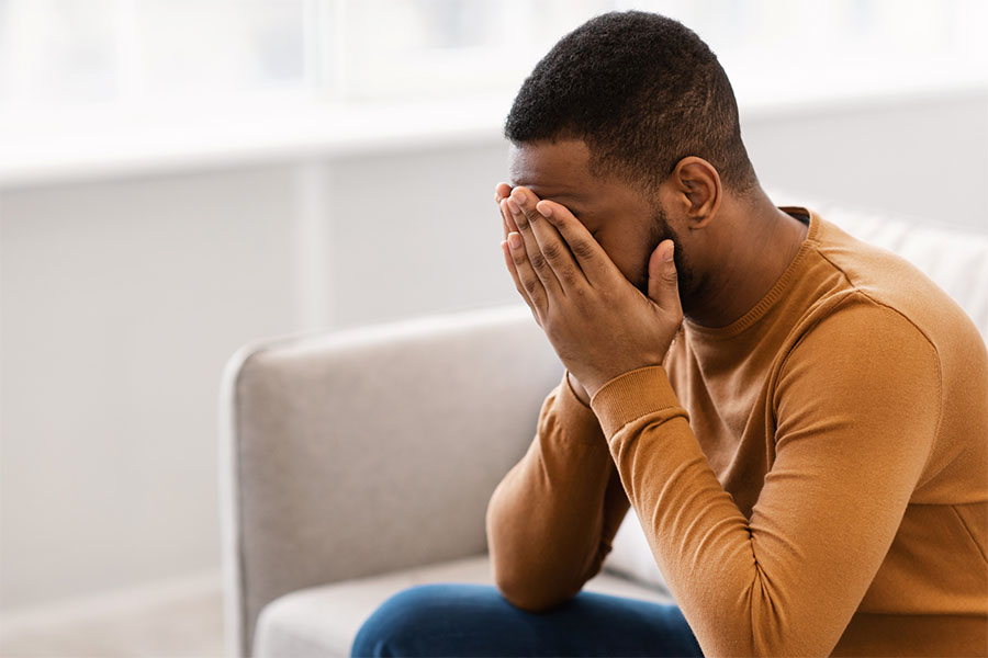 A man with co-occurring disorders of mental health disorders and addiction to prescription drugs working through difficult emotions during therapy sessions as a part of their treatment plan at Olympus Recovery's inpatient treatment program