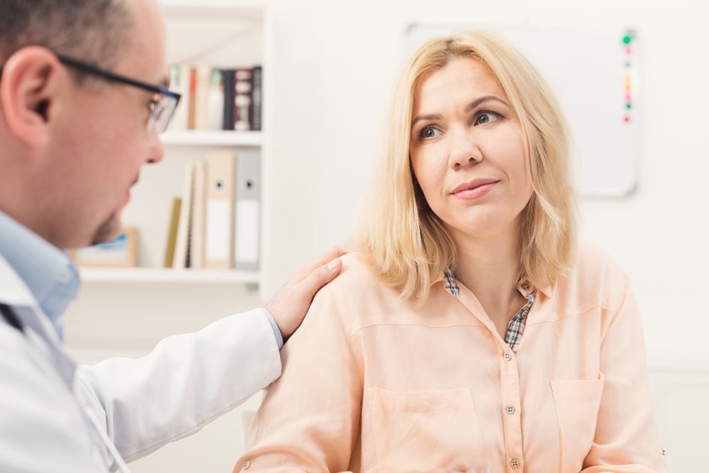 a woman speaking with a doctor at a mental health rehab