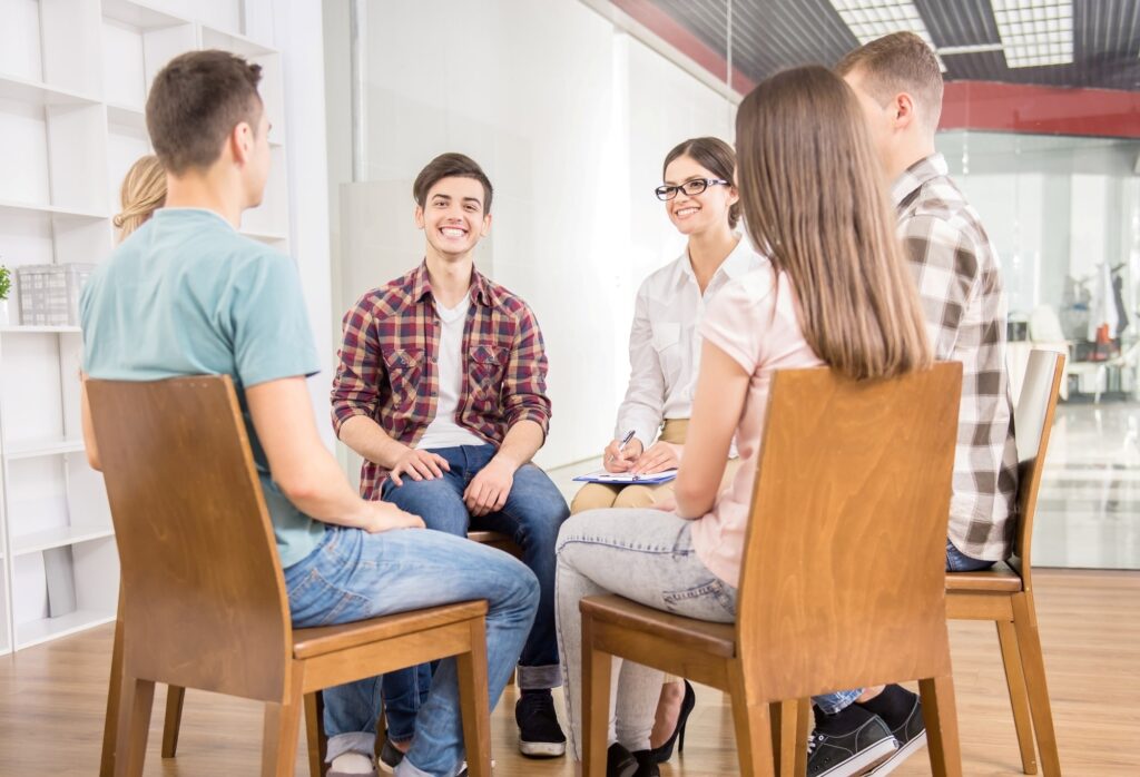 Participants in a group therapy session, a part of the drug and alcohol addiction and mental health treatment programs available at Olympus Recovery's dual diagnosis treatment center