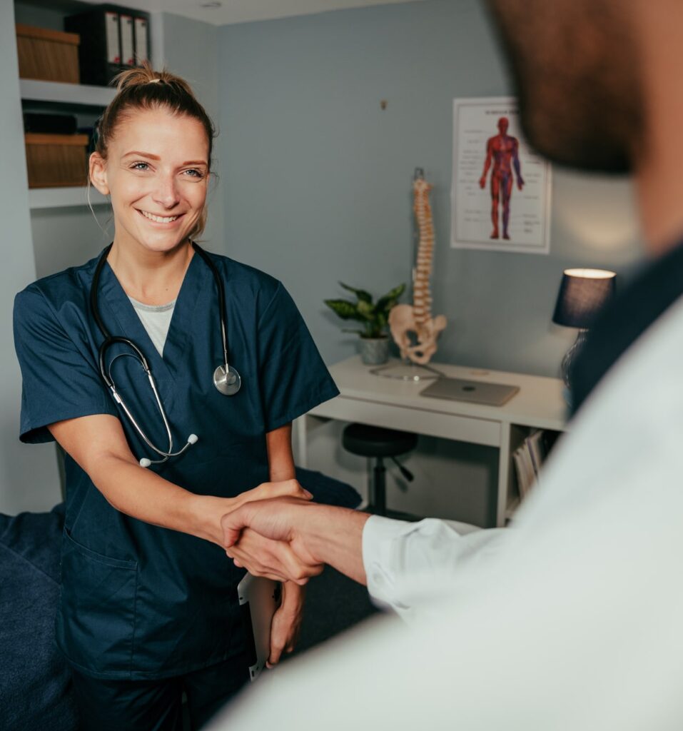 Medical staff greeting a man walking into a rehab center as part of an outpatient rehab program