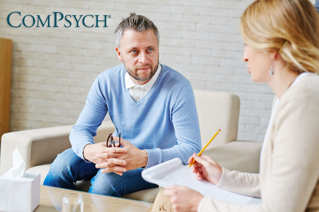 man and therapist discussing ComPsych insurance coverage for drug and alcohol rehab