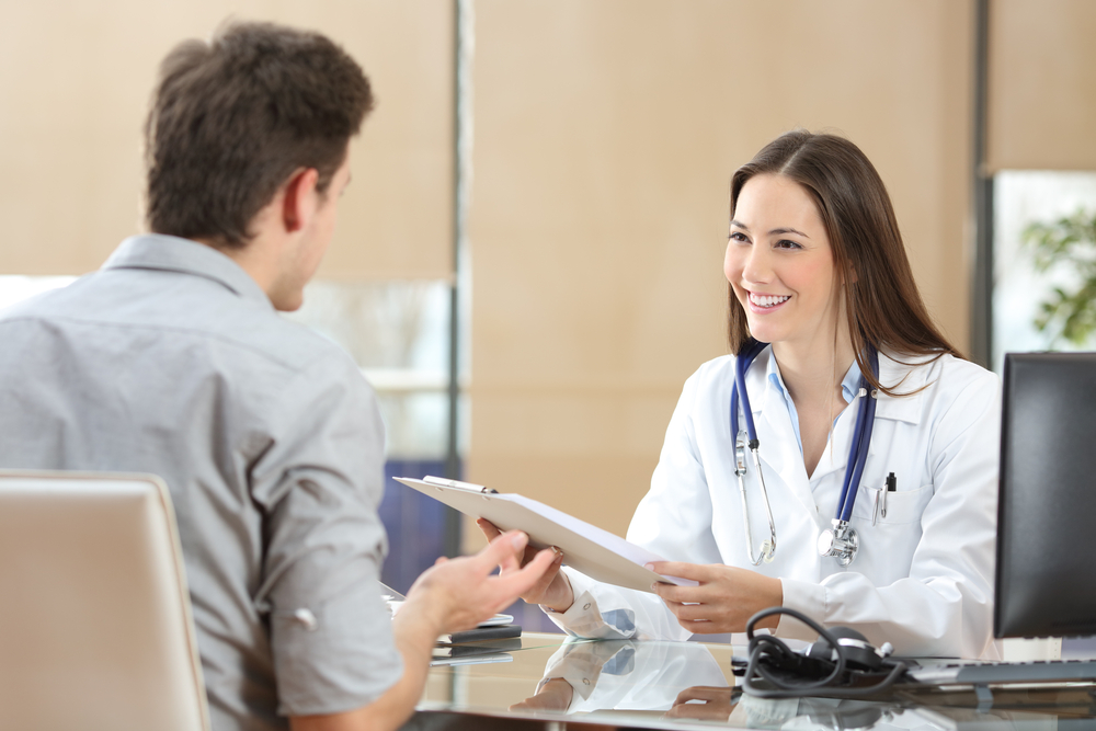 A person in need of PTSD and addiction treatment speaking with someone at Olympus Recovery about using their insurance coverage for treatment