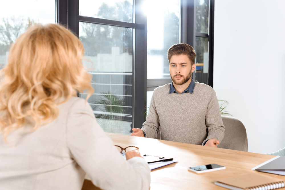 a man talking to a representative at Olympus Recovery about his compsych mental health rehab insurance